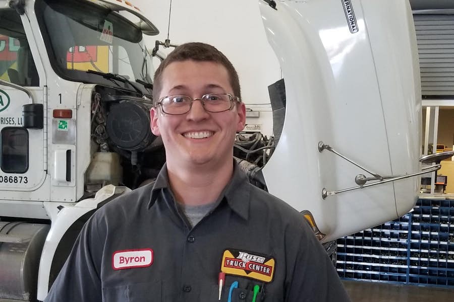 A person standing in front of a truck