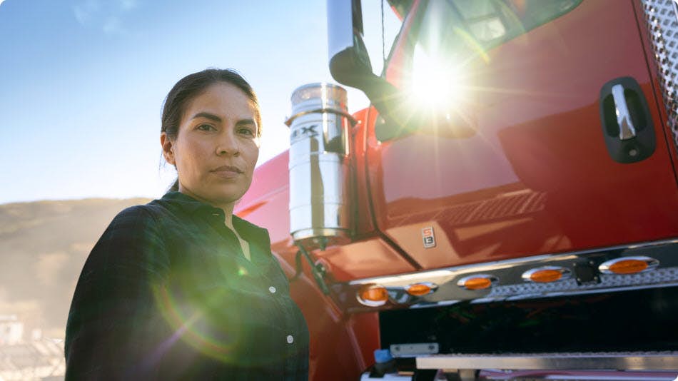 Woman standing in front of red truck