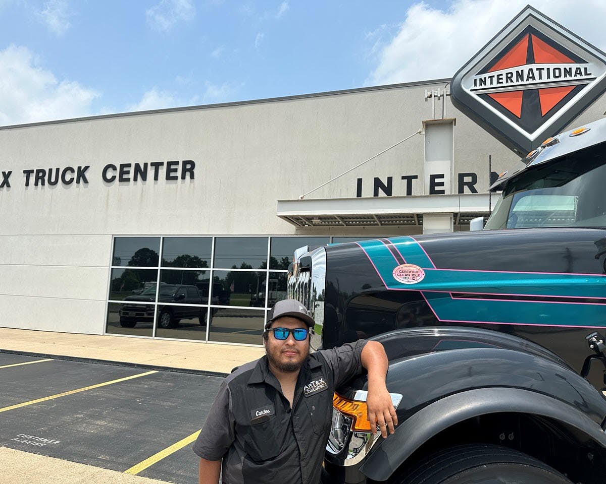 A person standing next to a truck