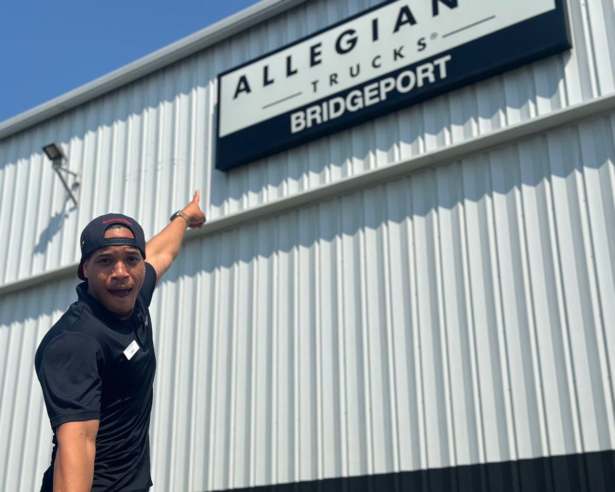 A person pointing at a sign