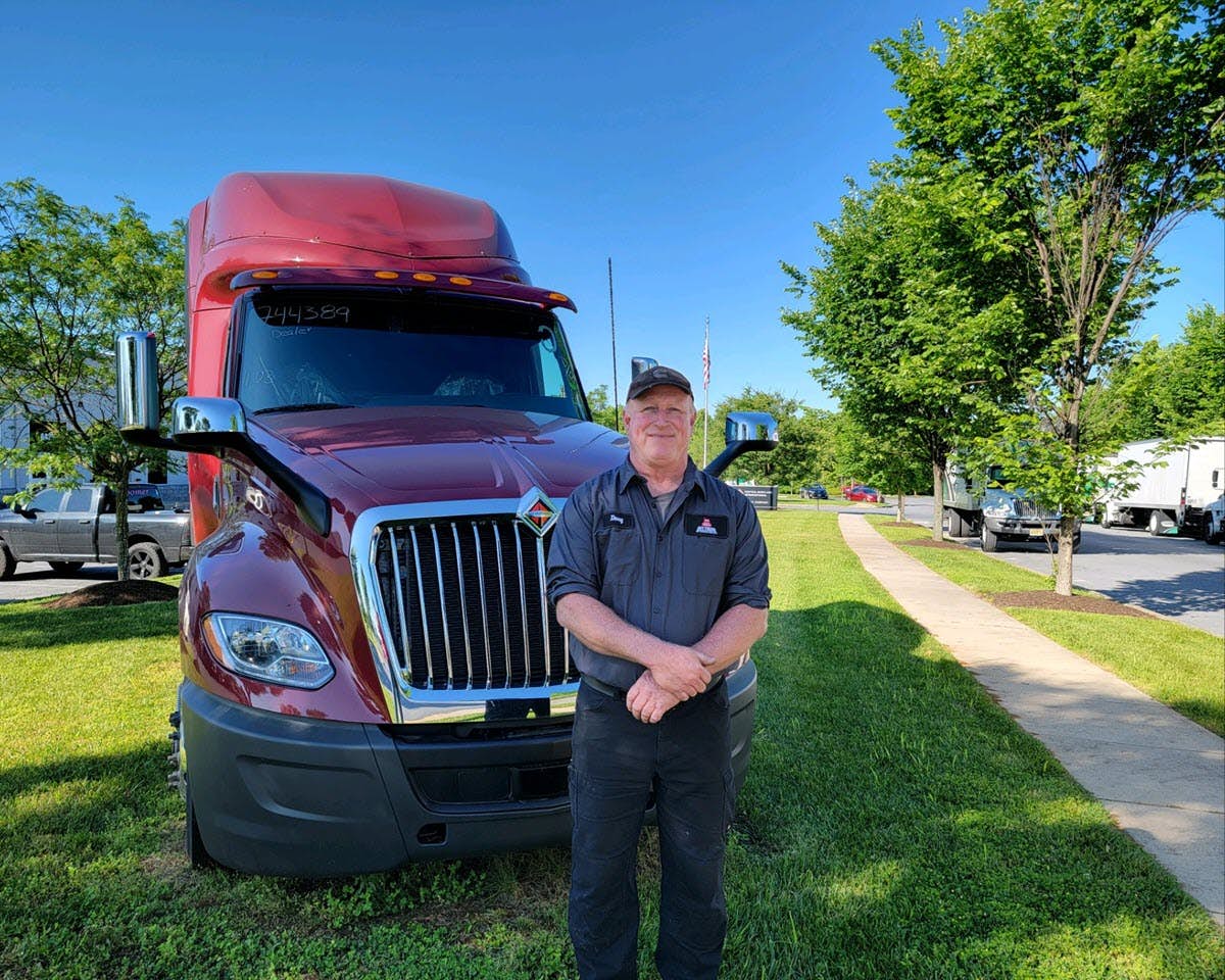 A person standing next to a truck