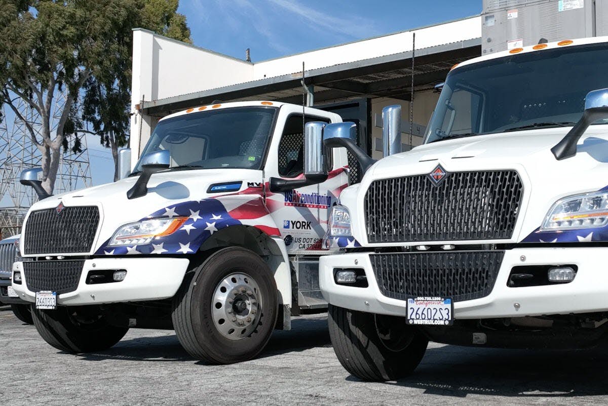 A two trucks parked in a parking lot