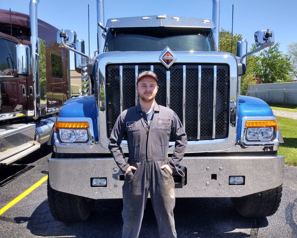A person standing in front of a truck