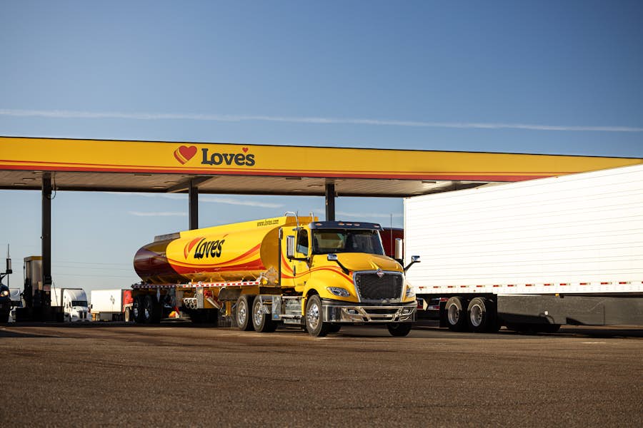 A yellow truck at a gas station