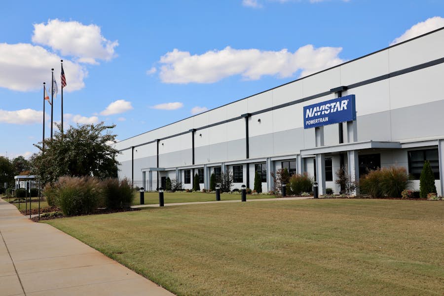 A building with a lawn and a sign