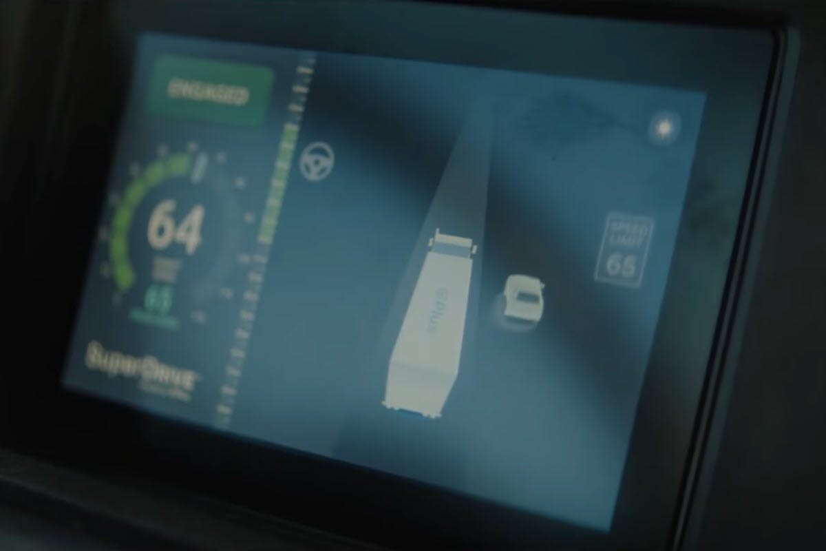 A screen with a screen showing a speedometer and a car