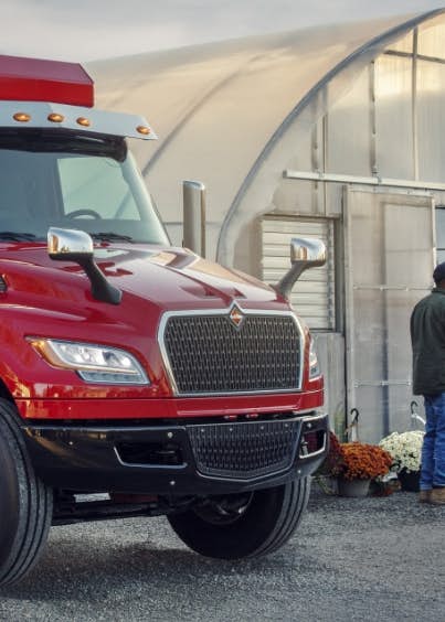 A red dump truck parked on a road