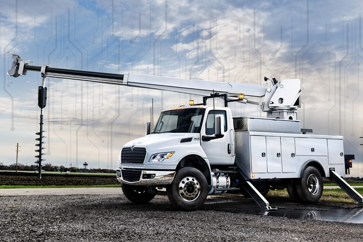 A white truck with a large crane