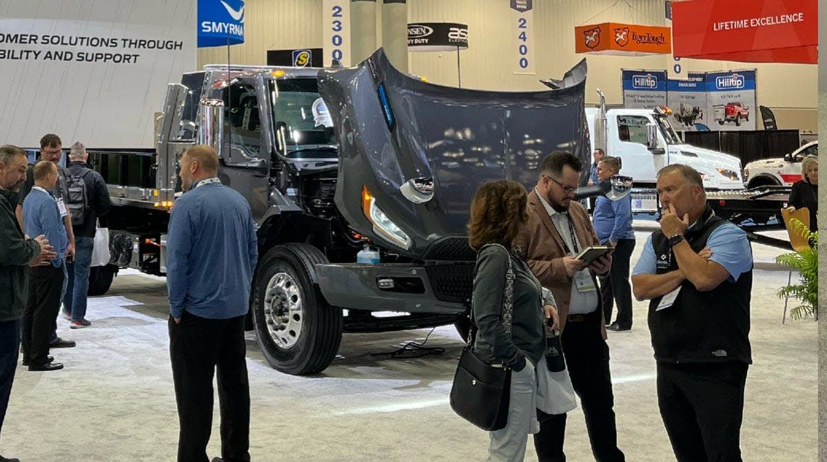 A group of people standing around a truck