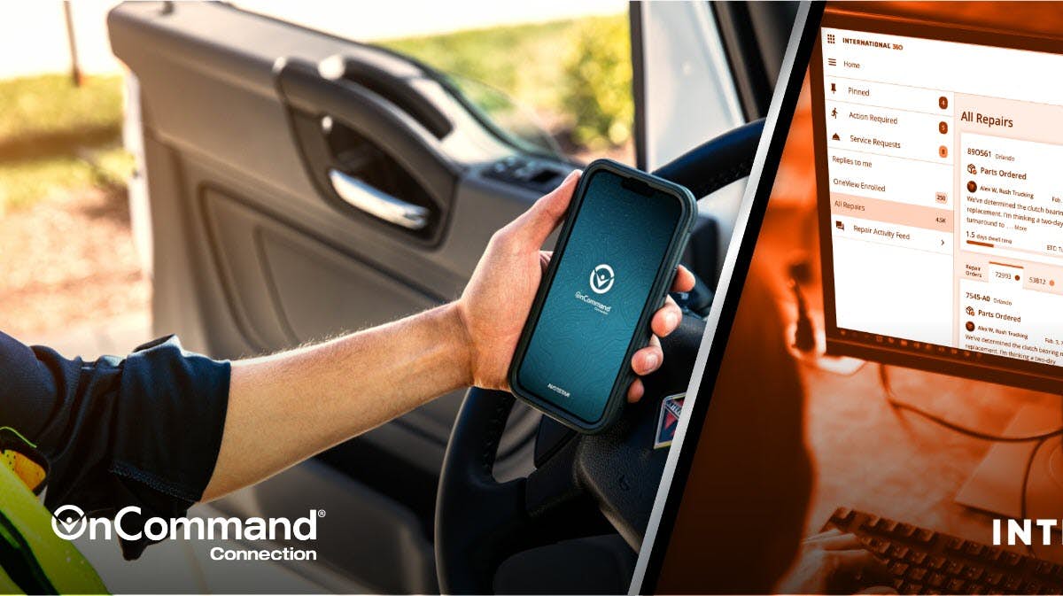 A hand holding a phone next to a computer screen