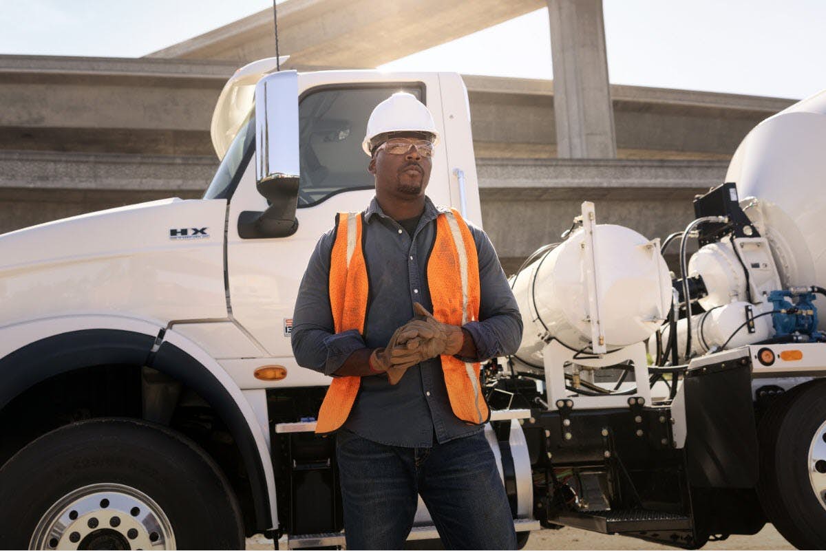 A person standing in front of a truck