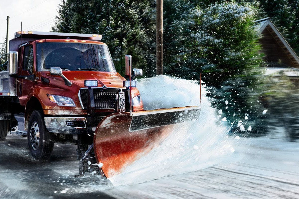 A snow plow truck on a road