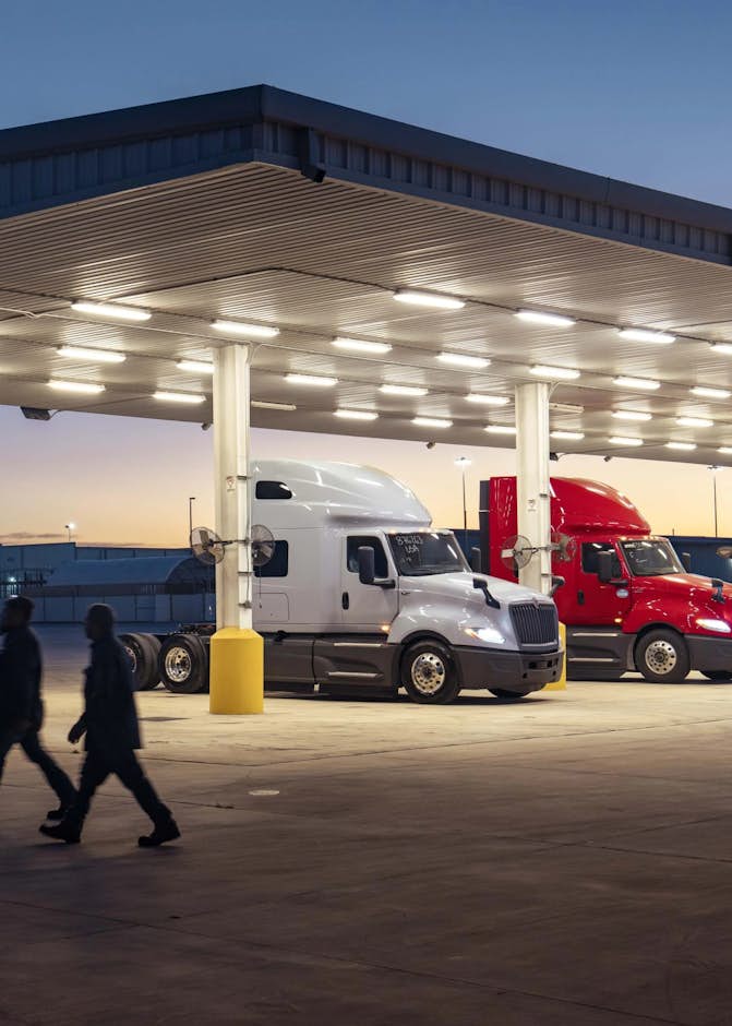 A couple of people walking under a covered building