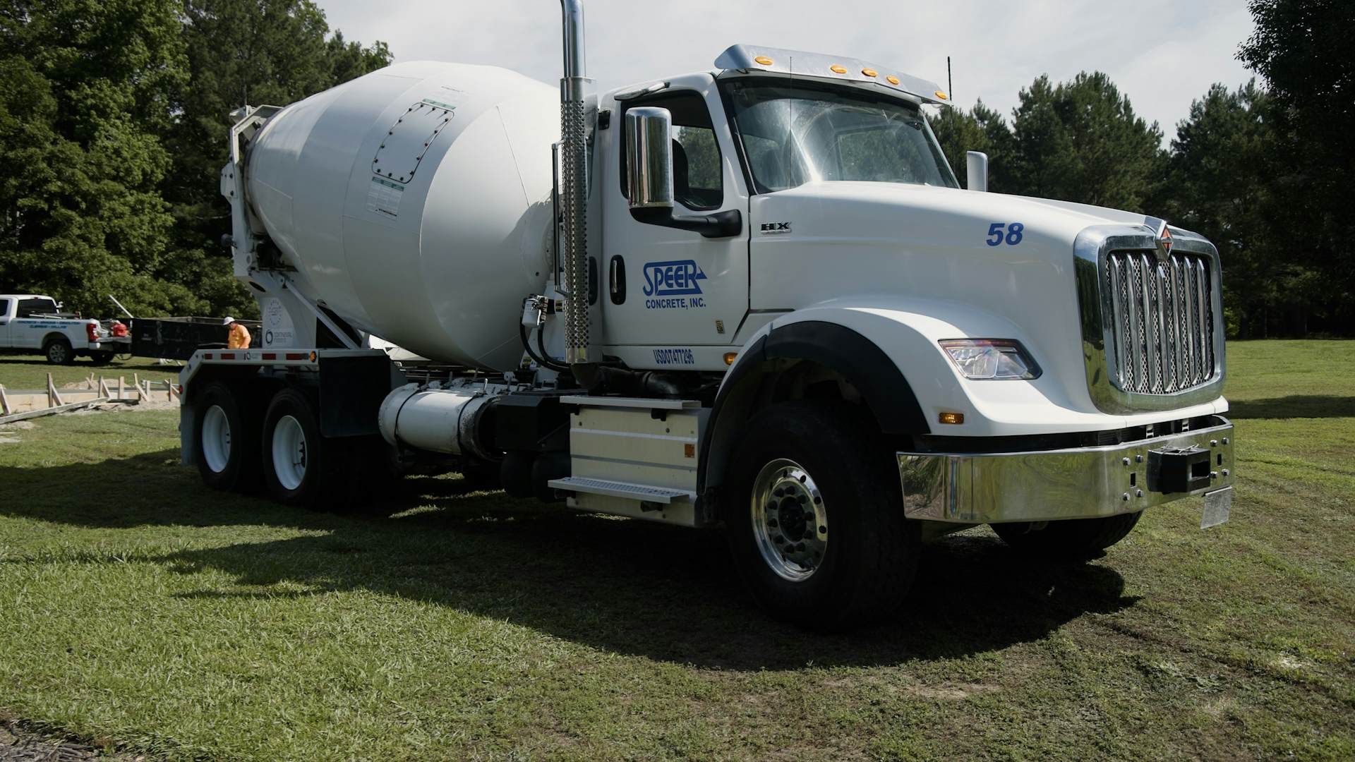International concrete truck parked in grass