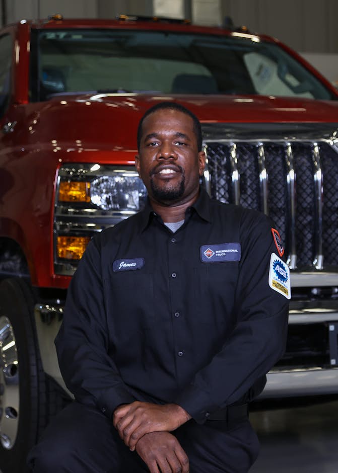 A person sitting in front of a truck