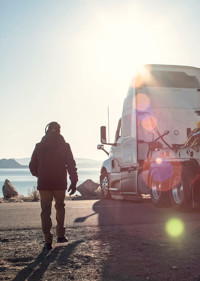 A person walking towards a truck