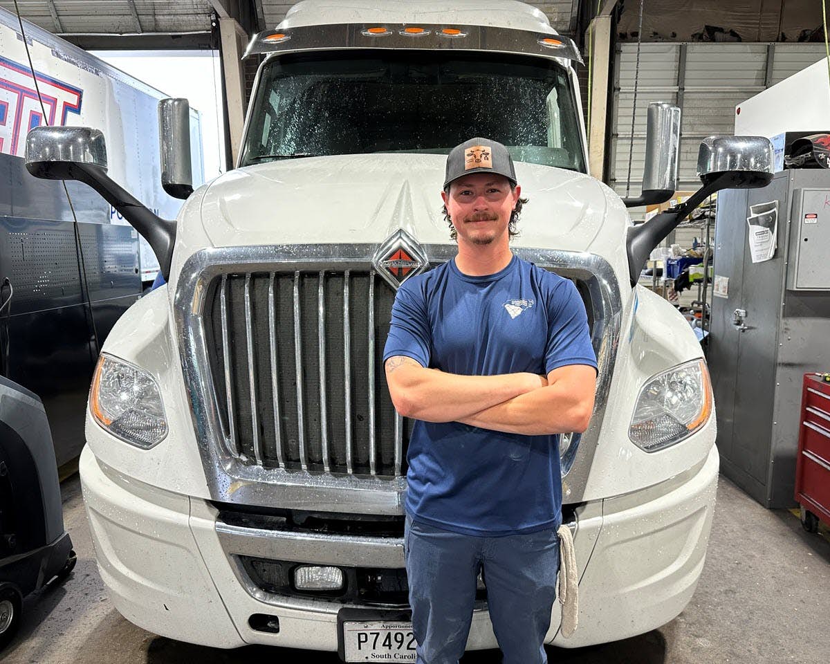A person standing in front of a truck