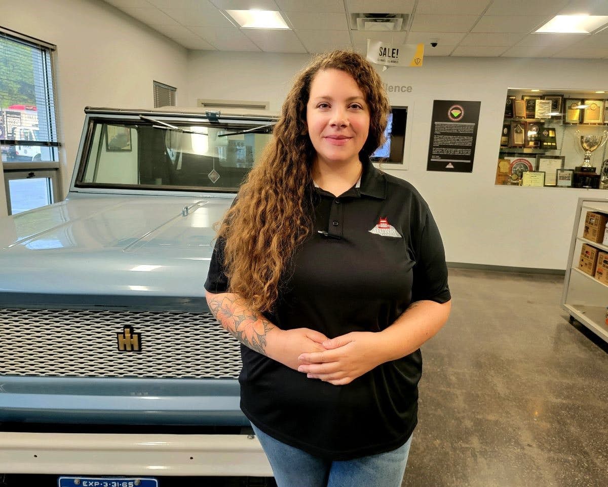 A person standing in front of a car