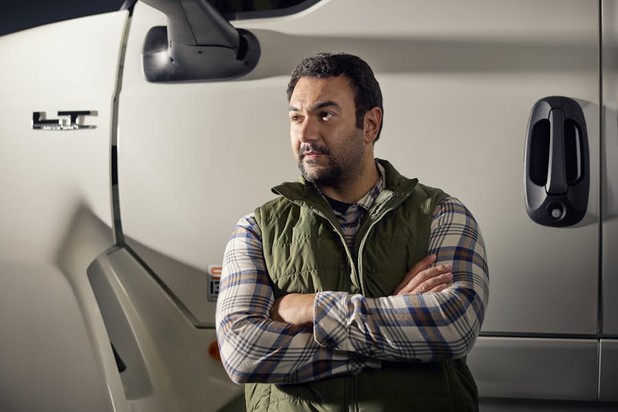 A person standing in front of a truck
