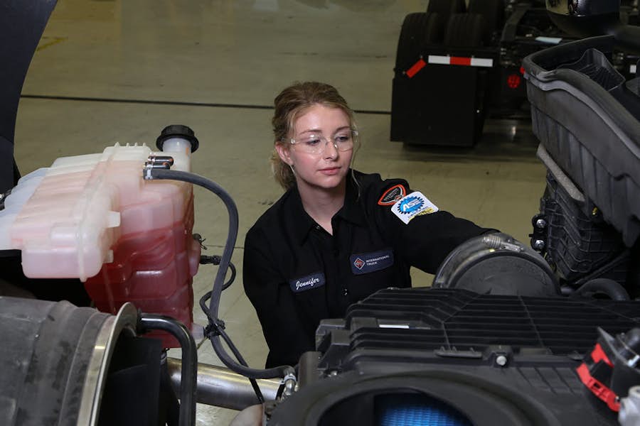 A person in a uniform working on a machine