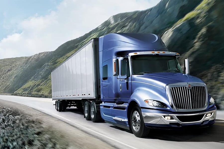 A blue semi truck on a road