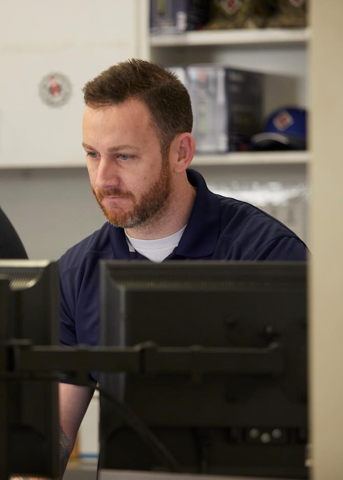 A group of men looking at computers